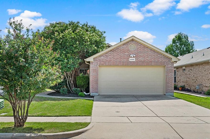Meticulously maintained by its ORIGINAL OWNER, this popular DR Horton floorplan stands out with unique features and a private lot. There’s ZERO CARPET. Rather, wood flooring everywhere except baths and laundry which feature durable, eco-friendly linoleum. The backyard offers rare privacy with no rear neighbors, instead backing to a natural buffer of dense foliage. The garage is enhanced with a smart-enabled opener, insulated doors, and HVAC ventilation, creating a protective, comfortable and functional space for hobbies, storage, or workouts. Exterior highlights include gutters, security lighting, a neutral color palette, and established perennial landscaping. A nearby community mailbox contributes to clean curb appeal. Inside, vaulted-shed ceilings and arched doorways create an open feel, complemented by recessed lighting, window coverings, a coat closet, and upgraded ceiling fans in the living and all bedrooms. The spacious dining area flows into the equally big, bright kitchen equipped with abundant built-in storage, a walk-in pantry, gas range, microwave, dishwasher, and disposal. The Kenmore side-by-side REFRIGERATOR WITH WATER DISPENSER CONVEYS, ALONG WITH THE KENMORE WASHER AND DRYER in the adjacent laundry room, which also includes shelving and a drip-dry rod. Utility spaces feature built-in organizational elements for efficient, clutter-free storage. The primary is ensuite with bidet, separate shower, and large walk-in closet. Both baths have upgraded shower wands and exhaust fans, with a curved rod in the secondary bath for added space. A sliding glass door leads to the covered patio, dine alfresco! A stone walkway connects the backyard to the front pedestrian gate along the wood privacy fence. Community amenities include walking trails, pool, park, playground, and half-court basketball. Convenient access to I-35 provides proximity to schools, medical facilities, shopping, and dining. Less than 10 miles from Iron Horse Golf Course or downtown Fort Worth.