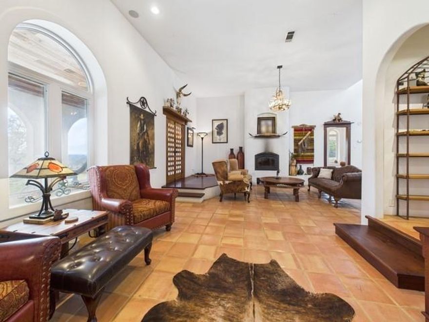 Looking for a Central American style retreat, without ever leaving East Texas? This stunning Spanish-inspired custom home sits on 5, fully fenced, picturesque acres & delivers an authentic, handcrafted feel just 10 minutes from downtown Athens. Thoughtfully designed for beauty, comfort, & energy efficiency, the home features a solid concrete frame with a stucco finish & a unique foundation of imported geothermal rocks. A rain-encatchment system, housed beneath the porch, waters the grounds surrounding the home, bringing sustainability & smart engineering together. With 2,565 sq ft, this unparalleled property welcomes you with wrap-around Saltillo-tiled porches showcasing peaceful countryside views in every direction. Inside, natural light fills the spacious living & dining areas accented by bullnose arches, custom wood beams, & hand-carved details throughout. Every room in the home offers direct access to the wrap-around porch, creating seamless indoor-outdoor living & capturing the feel of a traditional villa. The gourmet kitchen is a standout, offering floor-to-ceiling real-wood custom cabinetry, a long center island, double oven, pot filler, walk-in pantry, and 2 sinks, ideal for entertaining & everyday living. The primary suite spans an entire side of the home, offering lush pasture views from every window. The primary bathroom is a retreat of its own, complete with a deep soaking jacuzzi tub, large tiled walk-in shower, & a double vanity featuring custom Talavera sinks. A dedicated office can easily convert to a third bedroom if desired. Like the furnishings? Custom cabinetry & furniture are available for purchase separately. An asphalt driveway winds through the property, past the large workshop, perfect for all your projects, that is connected to its own deep well. The paved path continues, leading you to the home’s inviting entrance. A true East Texas oasis with the soul of a Latin hacienda! Homes like this are rare, remarkable, & unforgettable.