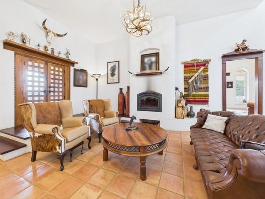 Looking for a Central American style retreat, without ever leaving East Texas? This stunning Spanish-inspired custom home sits on 5, fully fenced, picturesque acres & delivers an authentic, handcrafted feel just 10 minutes from downtown Athens. Thoughtfully designed for beauty, comfort, & energy efficiency, the home features a solid concrete frame with a stucco finish & a unique foundation of imported geothermal rocks. A rain-encatchment system, housed beneath the porch, waters the grounds surrounding the home, bringing sustainability & smart engineering together. With 2,565 sq ft, this unparalleled property welcomes you with wrap-around Saltillo-tiled porches showcasing peaceful countryside views in every direction. Inside, natural light fills the spacious living & dining areas accented by bullnose arches, custom wood beams, & hand-carved details throughout. Every room in the home offers direct access to the wrap-around porch, creating seamless indoor-outdoor living & capturing the feel of a traditional villa. The gourmet kitchen is a standout, offering floor-to-ceiling real-wood custom cabinetry, a long center island, double oven, pot filler, walk-in pantry, and 2 sinks, ideal for entertaining & everyday living. The primary suite spans an entire side of the home, offering lush pasture views from every window. The primary bathroom is a retreat of its own, complete with a deep soaking jacuzzi tub, large tiled walk-in shower, & a double vanity featuring custom Talavera sinks. A dedicated office can easily convert to a third bedroom if desired. Like the furnishings? Custom cabinetry & furniture are available for purchase separately. An asphalt driveway winds through the property, past the large workshop, perfect for all your projects, that is connected to its own deep well. The paved path continues, leading you to the home’s inviting entrance. A true East Texas oasis with the soul of a Latin hacienda! Homes like this are rare, remarkable, & unforgettable.