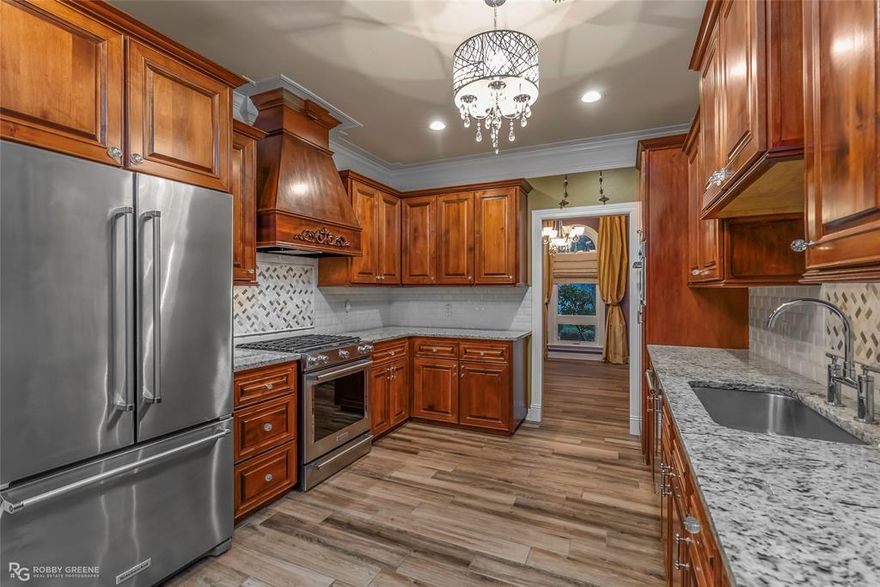 This stunning Dogwood Park residence exudes luxury and sophistication from the moment you arrive, set on a stately half-acre corner lot accented by elegant roof finials and timeless architectural presence. Inside, every detail reflects designer quality, including all-new Anderson vinyl windows, a full-home generator, and custom Restoration Hardware window treatments and rods. The gourmet kitchen impresses with designer chandeliers, rich stained cabinetry, a gas cooktop, and abundant storage, while the remote primary suite offers a serene retreat with a spa tub, dual sinks, and two large walk-in closets. The seller is conveying an exquisite Restoration Hardware vanity, tub, and fixtures—an exceptional bonus for the next owner to elevate the space perfectly. Two additional bedrooms are downstairs, with a fourth tucked away upstairs. The backyard is an entertainer’s dream, featuring a covered grilling pavilion complete with a built-in Green Egg and Blackstone griddle, along with a powered workshop and additional storage shed. Mature trees, lush landscaping, and full fencing create a private oasis, making this one-of-a-kind home the perfect blend of elegance, comfort, and elevated living in one of the area’s most desirable neighborhoods.