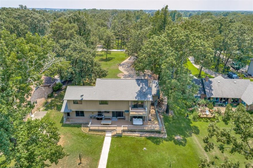 Beautiful waterfront home on Lake Fork with private covered boat house. New Bedroom added to 1st Floor.  New Cat 3 Roof.  Updated house with hardwood flooring, appliances, electrical panel and paint in the last few years so that the interior looks like a new home.  Towering mature trees all around an established small private community with a community boat ramp and a very laid back HOA. The landscaping is watered from the the lake pump to the property.  Enjoy the recent greenhouse. A 3 car garage big enough for your bass boat and toys! This is a rare lake house as the house looks great on a great lot and has a private boat dock that remained usable even when the lake water level was low a few years ago.  Buyer to verify any and all information.