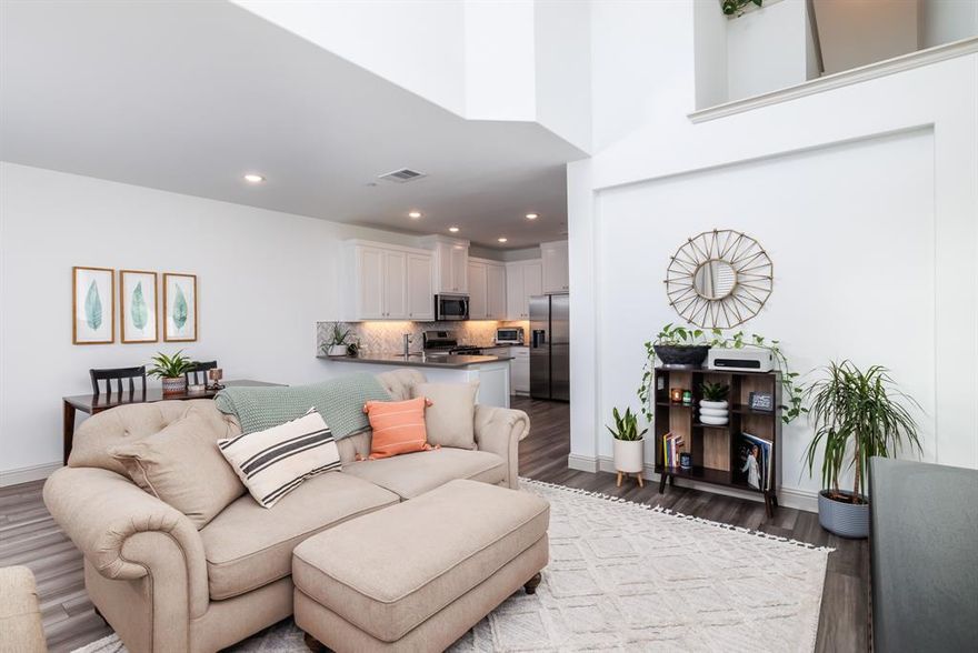 **ASSUMABLE LOAN AVAILABLE WITH QUALIFING FHA 6.375% *P & I FIXED AT $1638.33* WITH APPROX 15% DOWN** Immaculate townhome in desirable Harvest Community! CB JENI HOMES CARSON B floorplan. Like new - completed in 2022. Ideal for young professionals, frequent travelers, downsizing & anyone looking for low maintenance. Cozy front porch is a perfect spot for morning coffee. Open floorplan great for entertaining. Two-story family room ceiling provides a light & airy atmosphere. Dream kitchen features quartz counters, herringbone backsplash, SS appls, custom cabinets & more! 2 bdrms upstairs on opposite ends for privacy, 2 bathrooms, loft desk area & laundry closet. Primary bdrm offers large bath w- walk-in shower, double sinks, linen closet & large walk-in closet. Other amenities include luxury vinyl floors, plush carpet & quartz countertops in bathrooms. Location is nestled right in the heart of Harvest community, just steps away from the lake, pools & trails. *Fridge is negotiable.*