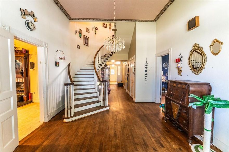 Only 4 blocks from the square, this charming 4 bedroom, 2.5 bath historical home comes with character and over 3,400 square feet on a large corner lot! A grand entrance includes high ceilings, an elegant curved staircase, and a hall to the backyard. To the right, you'll find a spacious living room with bay windows allowing lots of natural light, plantation shutters, and a decorative ceiling fan. A formal dining room connects the living room and the kitchen. The family chef will appreciate the gas cooktop, double ovens, island with granite, white shaker cabinets, an abundance of storage and countertop space, a prep sink, single basin sink, and a breakfast area. Off the kitchen is a laundry room with sink and more storage with built-in cabinets. Attractive wood floors and high ceilings flow throughout the first floor. At the back of the house, is the primary ensuite bedroom with a fireplace, jacuzzi tub, double sink, and separate shower. A room with a fireplace, built-in bookcases, & a door to outside, can be an office or bedroom. Upstairs are 2 additional guest rooms with vaulted ceilings and a full bathroom. This home has am ample amount of storage throughout. With over half an acre, take time to relax on the large back deck, the stone patio in a shady backyard, or on a wrap-around front porch. Invite guests to stay in a separate cottage-style building with loft, mini-split HVAC unit, and electricity. It can also be used for an office, gym, hobby area, or flex space. A concrete circle driveway off a side street provides easy access. If you've always dreamed of owning a historical home, then you'll want to put this on your list of ones to see!