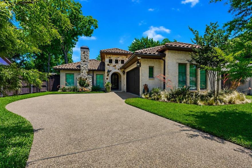 Marrying timeless design with refined modern living, this architect-designed custom Mediterranean home showcases hand-selected limestone, artisan masonry detailing, and a Spanish clay tile roof. A custom-made wrought iron door opens to seamless indoor-outdoor living spaces, while a wall of windows showcases a picturesque courtyard with a pool and covered patio.
Sunlight pours through walls of French doors as expansive living and dining spaces connect seamlessly beneath 11.5 foot ceilings, exposed wood beams, and rich hand-scraped hardwood flooring. The chef-inspired kitchen features Thermador professional appliances, custom cabinetry, designer lighting, oversized island seating, and spaces designed for both everyday living and effortless entertaining.
Thoughtfully designed around the central travertine courtyard and resort-style pool, the home offers exceptional indoor-outdoor flow with a covered terrace featuring a fireplace, built-in overhead heaters, and multiple lounging and dining areas.
The private primary suite opens directly to the patio and features a spa-inspired bath with a zero-threshold shower, soaking tub, dual vanities, and custom closet space. A flexible third bedroom with surround sound also functions beautifully as a media-family room.
Additional highlights include a wired indoor and outdoor sound system, solid-core doors, smart home and security features, dual-zone HVAC, and an oversized garage with epoxy floors, custom built-in cabinetry, a workspace, and a Tesla EV charger.
Rarely does a home combine authentic Mediterranean architecture with this level of craftsmanship, warmth, natural light, and modern refinement. Conveniently located near the Medical District, premier shopping, dining and entertainment, and a DART Light Rail stop with access to DFW Airport, downtown, the American Airlines Center, the Arts District, and Fair Park. This property combines exceptional accessibility with the privacy and elegance of a resort-style retreat.