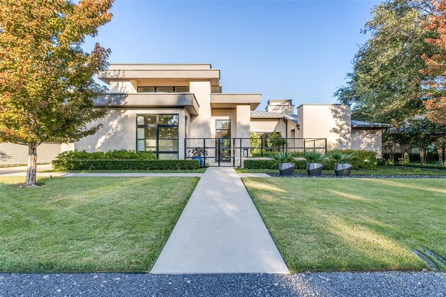 This contemporary home in Bluffview offers immaculate indoor and outdoor spaces with an open floor plan. Natural light cascades from the floor to ceiling windows and glass. Impressive cabinetry and a large island are the focal point to this gourmet center. Thermador stainless steel appliances and a nearby wet bar with wine refrigeration are great attributes. Primary bedroom is downstairs along with a secondary bedroom for guests. An office is close by as well as the utility room.  The spacious family room is conveniently located near the living areas. Up the stunning staircase is a central game room, as well as three guest bedrooms completing the second level. A covered patio with a seating area overlooking the spectacular pool and backyard complimented with mature landscaping and a firepit for lounging is another area to relax, making this a special outdoor retreat. This sleek interior blends with the multiple outdoor areas and has so much to offer.