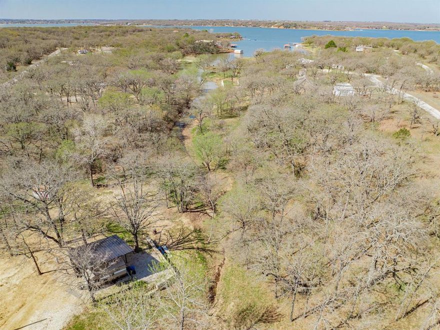 Just shy of a half acre this little slice of serenity is ready for you to make it what you want. Currenty has TWO camper electric hookups on the property with carports for the campers protection. Make it your weekend fishing get away or maybe a quiet AIR B&B whatever your hearts desire. Situated up above Lake Nocona you can step outside your door in the morning, drink coffee and day dream while gazing across the lake. Drivve by and take a look forypursellf or cantact me for a walk on the property.