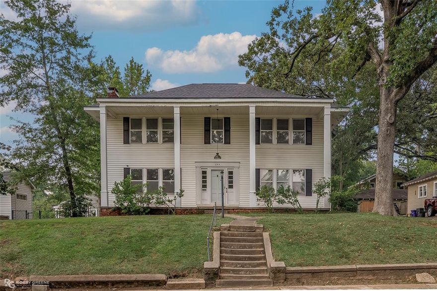 Nestled in the heart of the Gladstone Historic District, this stately colonial-style home offers a rare blend of timeless elegance and generous living space. Boasting 5 bedrooms and 2 full bathrooms, it showcases classic columns, original hardwood floors, and abundant built-ins that capture the charm of a bygone era. Expansive windows bathe each room in natural light, while a separate exterior entrance provides access to the upstairs living area and screened-in porch—perfect for relaxing or entertaining. The fully fenced yard features a side garden with an adorable shed, ideal for storage or a playhouse. Additional highlights include central heat throughout the home, air downstairs, and a detached garage for added convenience. Just minutes from Centenary College, LSU Ochsner’s Hospital, shopping, and dining, this historic treasure offers endless potential to create your dream home in one of the city’s most charming neighborhoods.