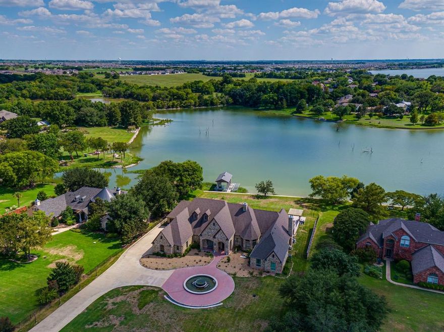 LUXURY RESORT-STYLE LIVING AT ITS FINEST! Situated on AN ACRE lot with MAGNIFICENT lakefront views of Lake Ray Hubbard! A story of timeless sophistication features a gourmet kitchen, hand-scraped hardwood floors, open-concept floor plan, vaulted ceilings, a large master suite, indoor gym, and exquisite outdoor living space with a private covered boat dock! This property features 6 bedrooms, 5 bathrooms, a formal dining room, and much more. The 5-star eat-in kitchen has granite countertops, large pantry, and tons of storage. Master suite includes an extraordinary master bath with separate tub and shower, separate vanities, and large walk-in closet. The lap of luxury awaits outside with the infinity pool and hottub with waterfront views, covered porch, outdoor kitchen, large lawn, and unimaginable view of sunsets! This beauty is a luxurious escape that you, your family and your friends will never want to leave! Experience the beauty firsthand!