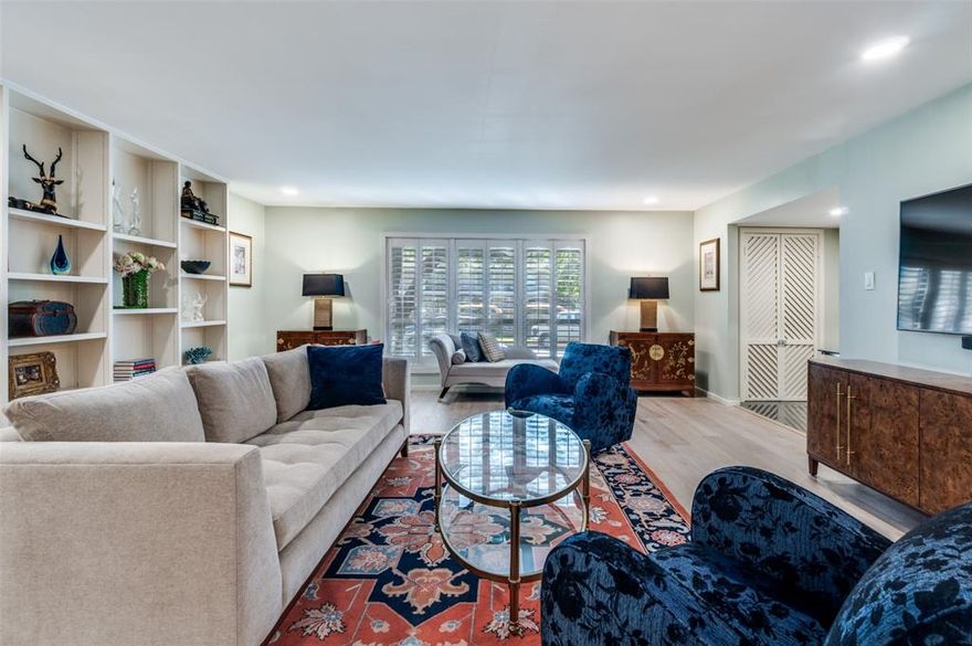 Sophisticated design and impeccable finishes define this elegant ground-floor condo in Preston Hollow’s “Behind The Pink Wall” neighborhood. Enjoy the spacious, easy-flowing floor plan, complemented by large picture windows that offer beautiful green views. Wood floors and custom lighting are featured throughout the home, along with meticulous details such as replaced or refinished doors with custom hardware and hinges. A floor-to-ceiling wall of built-ins decorates the roomy living area. The sleek, wide galley kitchen features custom cabinetry with under-cabinet lighting, glass tile backsplash, granite countertops, premium stainless-steel appliances, and a walk-in pantry with an additional utility closet. The spacious primary suite includes three closets, a separate laundry closet, and a shower bath with luxurious tile, marble, and fixture selections. A second bedroom and full hallway bath offer ideal flexibility for guests or a home office. Plantation shutters are featured throughout, and every window in the unit has been replaced for better insulation and comfort. Park Carillon is a quiet, well-maintained community with classic mid-century architecture, lush landscaping with mature live oaks, and a central pool courtyard that’s scheduled for a refresh in the next few months. Located in one of Dallas’s most desirable areas, this Preston Hollow gem offers easy access to Preston Center, NorthPark, and Preston Royal shopping and dining. Monthly HOA dues cover all utilities for worry-free living.