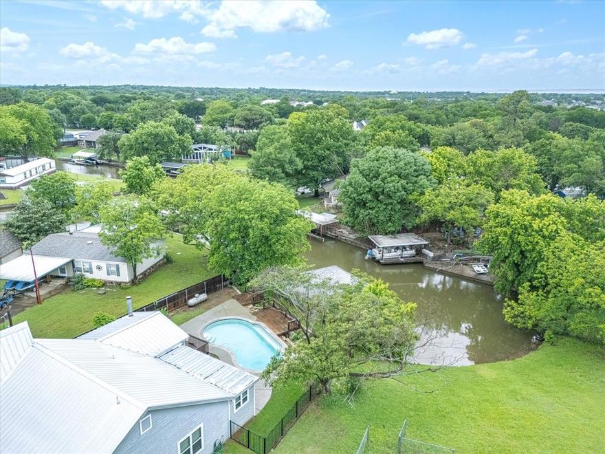 SPECTACULAR LAKE GRANBURY RETREAT! Seize the opportunity to own this remarkable property, the perfect summer escape or an exceptional Airbnb investment! As you enter your dream getaway, you’ll be captivated by the thoughtful renovations throughout, featuring brand new carpet and a fresh coat of paint. This stunning home boasts two luxurious master suites on the main floor, each equipped with elegant bathrooms and spacious walk-in closets for ultimate comfort. An inviting office space located just off one of the master suites offers an ideal setting for remote work or quiet study sessions. 

Venture up the private staircase to discover a delightful third bedroom, perfect for guests or family. The beautifully designed kitchen is a chef's dream, featuring granite countertops and stainless steel appliances, all overlooking the expansive living area complete with a cozy wood-burning fireplace. Get ready to entertain friends and family on the ample outdoor patio, or unwind by the sparkling pool while soaking up the warm Texas sunshine. Boating enthusiasts will love the exclusive access to Lake Granbury right from your own backyard! Don’t let this incredible opportunity pass you by!
