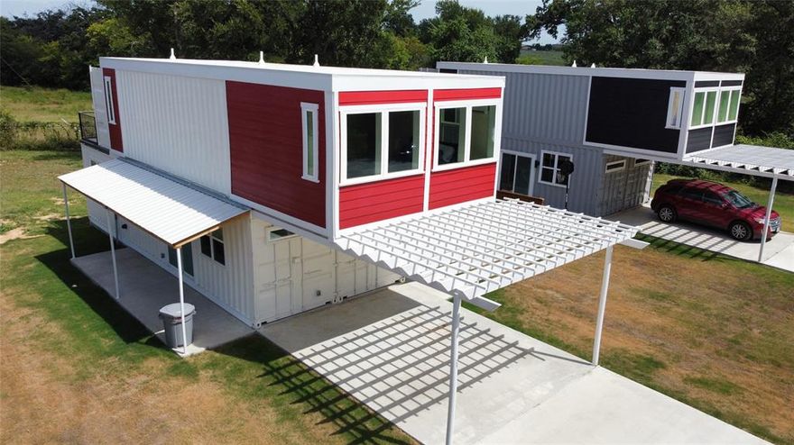 Experience modern design and sustainable living in this striking 3-bedroom, 3-bath container home on a spacious lot in Commerce, TX. The open-concept layout features a bright living area, a stylish kitchen with granite countertops, stainless steel appliances, breakfast bar seating, and custom cabinetry. The primary bedroom includes a private ensuite bath, while the additional two full baths are conveniently located for guests and secondary bedrooms. Upstairs, enjoy a private balcony perfect for relaxing or entertaining. Additional highlights include luxury wood-look vinyl planks throughout, split-unit HVAC systems, and a dedicated laundry space with a stackable washer and dryer. The large lot offers plenty of room for gardening, outdoor activities, or future additions. Ideally located just minutes from shopping, dining, East Texas A&M University, and the recreational opportunities of Lake Cooper, this one-of-a-kind property blends comfort, style, and functionality. Owner financing available with 10% down, up to 30 years, and using the current interest rate.