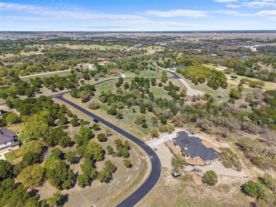 Set within a scenic golf course community in Cleburne, this 0.325-acre homesite offers a rare opportunity to build in a setting where open views, rolling terrain, and established surroundings come together. The community features winding roads, mature trees, and a thoughtfully designed layout that creates both privacy and a sense of connection. With close proximity to the clubhouse, golf course, and community pool, the lifestyle here is centered around relaxation and recreation without sacrificing everyday convenience. Whether you're envisioning a custom home with outdoor living space or simply looking for land in a setting that holds long-term appeal, this property provides a strong foundation to bring your vision to life. Opportunities like this continue to attract buyers who value space, views, and a community that feels intentionally designed.