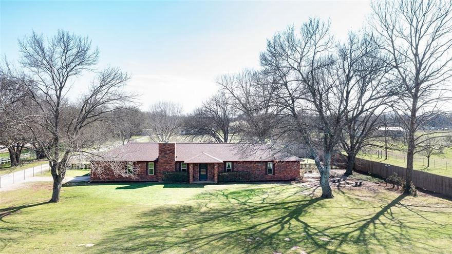 Enjoy peaceful country living on 2.98 acres beneath mature trees in this 3-bedroom, 2-bath home offering privacy, comfort, and timeless appeal. From the moment you arrive, you’ll notice inviting curb appeal, a shaded front yard, and a thoughtfully designed layout that makes everyday living feel effortless. New roof in 2025!
Inside, natural light fills the bright spaces, creating an airy and inviting feel throughout the home. The gourmet kitchen is a true centerpiece, featuring granite countertops, a spacious island with a built-in beverage fridge, and ample cabinetry with great prep space. It flows seamlessly into the dining and living areas—perfect for entertaining or simply enjoying time at home.
A cozy wood-burning fireplace anchors the living space, while a versatile bonus room provides endless possibilities as a game room, fitness area, playroom, or second living space. A separate office area offers a dedicated spot for work or study. The primary suite offers a peaceful retreat with abundant natural light, and beautiful flooring throughout adds warmth and a cohesive feel.
Step outside to discover private courtyard spaces, ideal for relaxing or entertaining, with room for seating, a fire pit, or garden features. The property also features excellent storage and workspace, including two large shops, a 110v storage barn for an RV, boat, or camper, and a separate insulated 220v workshop—perfect for hobbies or a small business, with space for projects, tools, and equipment.
If you’re looking for space, versatility, and a serene setting, this property delivers. Conveniently located in Wise County—just 20 minutes from Lake Bridgeport and offering a short commute to DFW Airport, Denton, or Fort Worth—you’ll enjoy peaceful living with easy access to shopping, dining, and local amenities.
Come experience it for yourself and see why this property feels like your own private escape—make this yours today with your finishing touches and make it truly your own retreat!