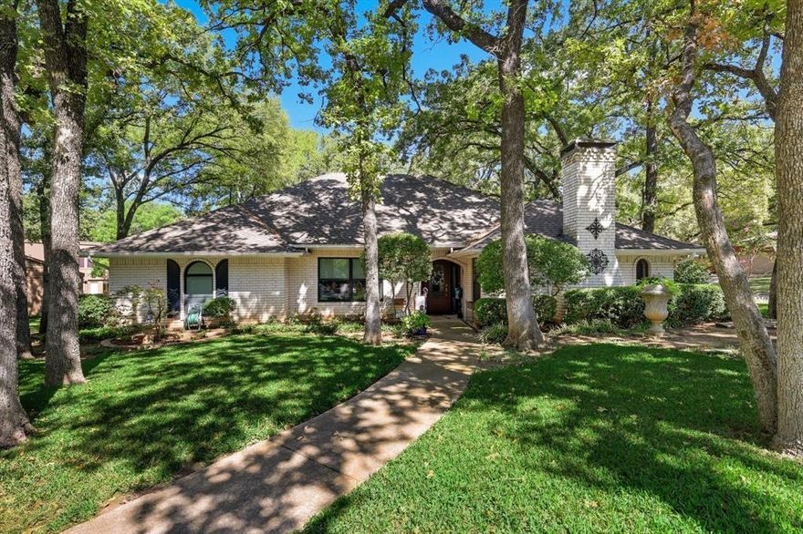 If you’ve been waiting for a beautifully maintained Arlington home in a timeless neighborhood, your wait is over. This cherished residence, lovingly cared for by long-time homeowners, sits on a corner lot, surrounded by mature trees and lush landscaping. Inside, you’ll find a flexible and thoughtfully designed floor plan currently used as a 3-bed 2.5 bath, with optional living areas that can easily adapt to your lifestyle, including a room that’s ideal for a fourth bedroom, office or hobby space.
During renovation, the den was expanded, featuring a wall of glass with sliding doors leading to a covered patio, a built-in wall of cabinetry and shelving, pantry storage, and a built-in desk for comfort, style and function. The kitchen has been updated with Corian countertops, a granite-topped island with convenient pull-out drawers for trash, recycling, and spices. Throughout the home, new windows, flooring, and smooth ceilings have replaced outdated features reflecting attention to detail.
The front living area offers flexibility — once a formal dining room, now a sitting room, it can easily be reimagined to suit your needs. The large front entertaining room features a wall of red oak cabinetry with glass shelving and lighting. It conceals an original brick fireplace in the center that could be restored. The c1970 wet bar was left in place!
The primary suite offers a spacious ensuite bath featuring three closets, dual vanities, and a walk-in shower where a marble tub once stood. A private door leads from the suite to the home’s most stunning feature - the covered back patio, designed as an elegant extension of the home with a canopy roof that allows natural light to filter through. Beyond the custom iron gate of the patio, the backyard feels like your own private park.
This neighborhood is one where community still thrives — with an active garden club and events. Come see why this home has been treasured, and imagine making it your own for years to come.