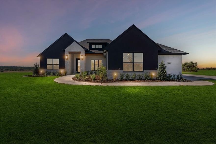 Experience the perfect blend of luxury and country living in this brand new home by award-winning Couto Homes. This Modified Kingsburg Classic Series plan offers 4 spacious bedrooms, 3 bathrooms, a private study, game room, and an oversized 3-car garage — all thoughtfully designed across 2,750 sq. ft. of living space on just over 2 acres in the gated community of Lanzara Ranch. Step through the impressive 8-foot iron entry door into an inviting open-concept layout with a warm floor-to-ceiling stone fireplace, rich wood-beamed ceilings, and large windows that fill the home with natural light. The chef’s kitchen boasts leathered granite countertops, a large center island with breakfast bar, coffee bar, gas cooktop, and built-in microwave and electric oven — perfect for entertaining or everyday living. The private primary suite offers a luxurious retreat with a spa-like ensuite featuring dual vanities, soaking tub, walk-in shower, and an extraordinary closet. There is a dedicated game room that provides extra space for fun and relaxation. The 3-car garage features epoxy flooring and a spacious driveway, ensuring room for everyone. Enjoy peaceful country sunsets from your expansive lot while still being conveniently located between Godley and Granbury. Come see it — life happens here!
