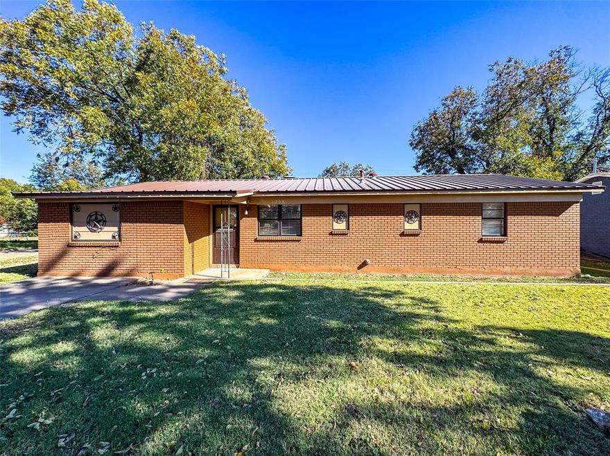 Welcome home to this lovely three-bedroom, two-bath residence offering comfort, versatility, and classic curb appeal. Featuring a durable metal roof, inviting brick façade, and excellent landscaping, this property stands out with its shaded yard and generous outdoor space. Inside, you’ll find multiple living areas—perfect for a formal sitting room, playroom, home office, or media space. The kitchen comes fully equipped with all appliances and connects seamlessly to the cozy dining area. A wood-burning fireplace adds warmth and charm, especially during the cooler months. The primary suite includes its own private bathroom for added convenience, while two additional spacious bedrooms and a second full bath provide plenty of room for family or guests. Storage is no issue here—this home offers multiple storage rooms along with a completely covered cellar ideal for storm protection or extra storage needs.

 With parking for up to four vehicles and a location on a desirable corner lot, this property blends function and style for everyday living. Don’t miss your chance to make this versatile and comfortable home your own!