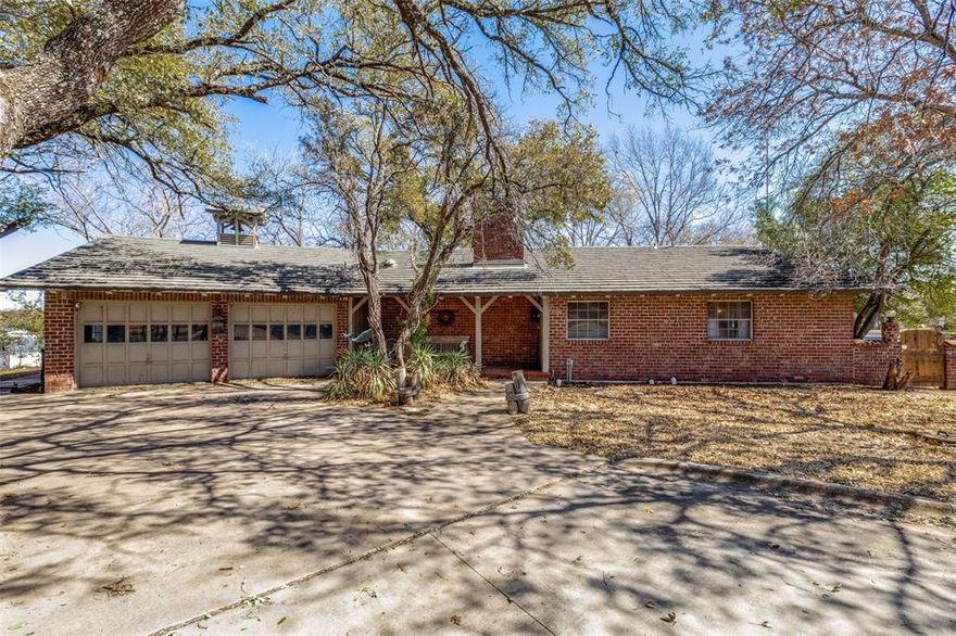 Just in time for summer, this 1.131 acre Eagle Mountain Lake property is one you don’t want to miss! The gated entrance opens to a long driveway leading to the 2 bed 2 bath main home and separate 1 bed 1 bath casita. Built in 1970, the home is filled with character from the brick floors and wood beams to the retro kitchen appliances. The peaceful porch overlooking the lake is the perfect spot to start and end your day. This lakefront lot is stunning and presents a great opportunity to add on, renovate, and build your dream lake home. The boat ramp was extended and upgraded in 2010, New septic tank installed 2004, New roof (Metal Shake Decra) replaced in 2012, and the HVAC, furnace, and hot water tank replaced within the last 10 years. The location feels like such a private oasis that you would never know you’re only a short 20 minute drive from the city and all that you could need.