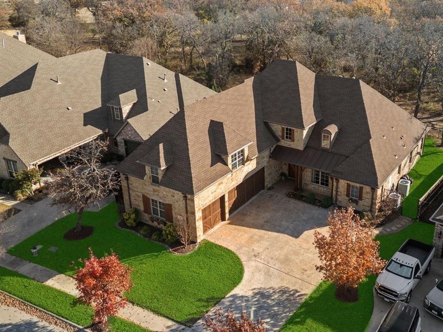 Welcome home to 304 Boonesville Bend! Nestled in a private enclave of Argyle, this exceptional custom home offers both privacy and convenience. Situated across the street from a beautiful wooded park and backing to heavily treed acreage adds to the uniqueness and charm of this beautiful home.  The partially gated community ensures a secure and serene environment, perfect for family living.  As you enter, you're greeted by an inviting study with a gorgeous park view, beautifully designed stairway and a spacious open-concept kitchen and family room, ideal for both entertaining and everyday relaxation. The kitchen features beautiful finishes, a large island, a well designed buffet wall to feature all of your prized dishes and a walk-in pantry, making meal prep a breeze. Adjacent to the family room is a cozy, private master retreat, designed for ultimate comfort and relaxation. This sanctuary includes a generous en-suite bathroom with dual vanities, separate shower and spacious walk in closet. The home's large laundry room and additional storage spaces, including a walk-in pantry, make organization simple and convenient.  Upstairs, you'll find two spacious bedrooms, a large game room, and a flexible bonus room that can serve as a nursery, additional office, or even a kids' bunk room. This versatile space ensures that the home adapts to your needs as they evolve.  The oversized 3-car garage provides ample space for vehicles, tools, and outdoor gear. For outdoor enthusiasts, the cozy covered back patio features a built-in grill and fireplace, offering an inviting space for gatherings or quiet evenings spent enjoying the peaceful surroundings. This home combines thoughtful design, functional spaces, and a prime location with a short walk to the middle school, offering a perfect balance of luxury and everyday practicality.