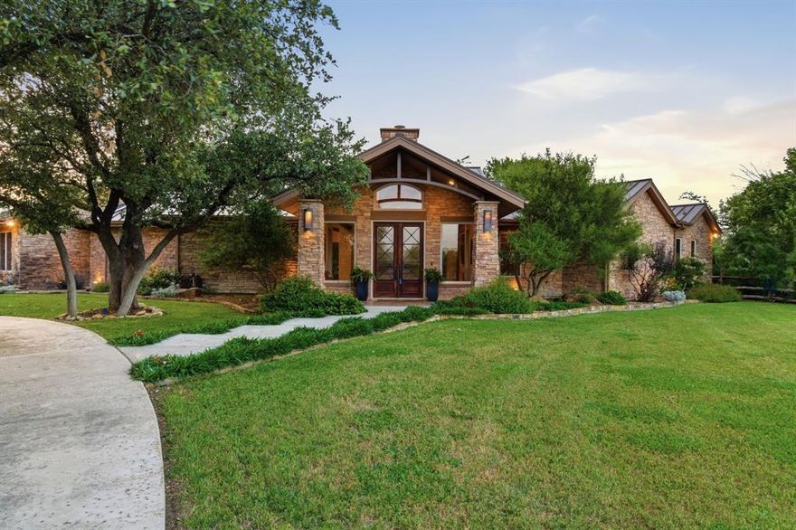 Perched in one of the area’s most breathtaking settings, this extraordinary property offers panoramic views that feel endless — where you can see for miles just driving home. Surrounded by towering trees and peaceful countryside, it feels like a private forest retreat while still being conveniently located just minutes from the highway and in Aledo ISD, this location is truly a rare jewel.

Designed for both luxury and lifestyle, the property features a beautiful vineyard, raised herb gardens, greenhouse, and a large barn perfect for horses, hobbies, extra vehicles, or equipment storage. Huge plus, it is ag exempt! 

The backyard living space feels like a private resort, complete with an expansive back porch and a custom pergola with remote-controlled open and close functionality — ideal for entertaining or relaxing year-round. Multiple seating areas create the perfect setting for gatherings under the Texas sky.

Inside, the custom-built home — completed in March 2012 — is unlike most properties on the market, showcasing dramatic oversized windows, stunning stacked rock accents, and an abundance of natural light throughout. Every space was thoughtfully designed to bring the outdoors in while highlighting the home’s unique architectural character and scenic surroundings.

A separate guest house offers incredible flexibility for extended family, parents, older children, guests, or even a private office or studio space. Combining privacy, beauty, functionality, and convenience, this one-of-a-kind estate delivers an exceptional opportunity to enjoy refined country living without sacrificing accessibility.