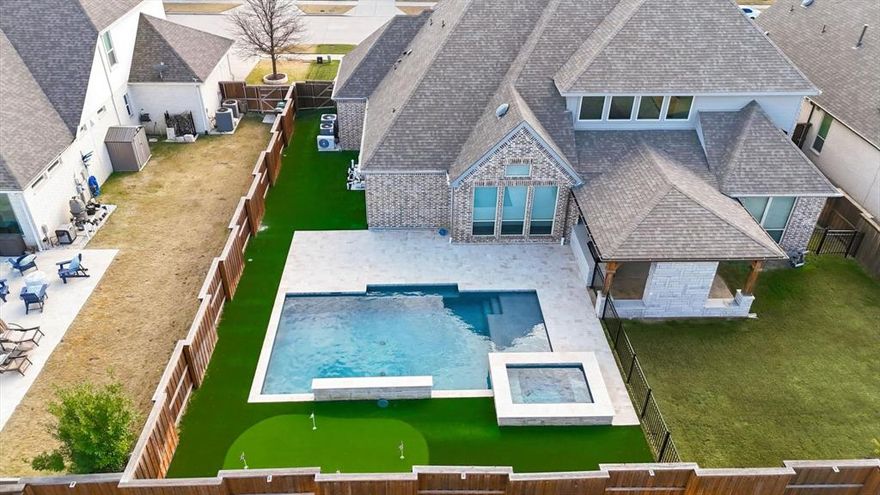 Stunning American Legend home in the highly desirable Windsong Ranch community, located within walking distance to the breathtaking Crystal Blue Lagoon, elementary school, fishing ponds, jogging paths, and beautiful parks. This thoughtfully designed home features an open floorplan with wood floors, blinds throughout, and numerous high-end upgrades in an award-winning master-planned community known for exceptional lifestyle amenities.
The chef’s kitchen flows seamlessly into the breakfast nook and living area and offers newer appliances, a large island, granite countertops, a Blanco granite sink that is scratch and stain-resistant, a butler’s pantry, and abundant cabinetry. The living room features soaring ceilings and a cozy gas fireplace with gas logs. A formal dining room sits just off the kitchen, perfect for entertaining. Study has new wood floors that were added and is located at the front of the home.The oversized primary suite provides a luxurious retreat that overlooks the beautiful pool and bathroom is a dream with separate vanities, a garden tub, spacious walk-through shower, custom cabinetry, and a California his-and-hers closet with pull-out mirror, accessory racks, and generous storage.
The backyard is built for relaxation and entertaining with a turf-and-grass layout, an oversized covered patio, built-in outdoor kitchen with grill, refrigerator, trash enclosure, and TV, plus newly added stunning saltwater pebble-tech pool and spa reinforced with Helical piers and sump drainage protection and a putting green to get that extra practice in.
Additional upgrades include a 3-car garage with climate-controlled single bay, tankless water heater, sprinkler system, enhanced air filtration, generator connection, EcoWater whole-home softener and reverse osmosis system with alkaline filtration, and a beautifully finished laundry room with dual LG wash towers and Blanco granite stain and resistant sink.This incredible home truly has it all.