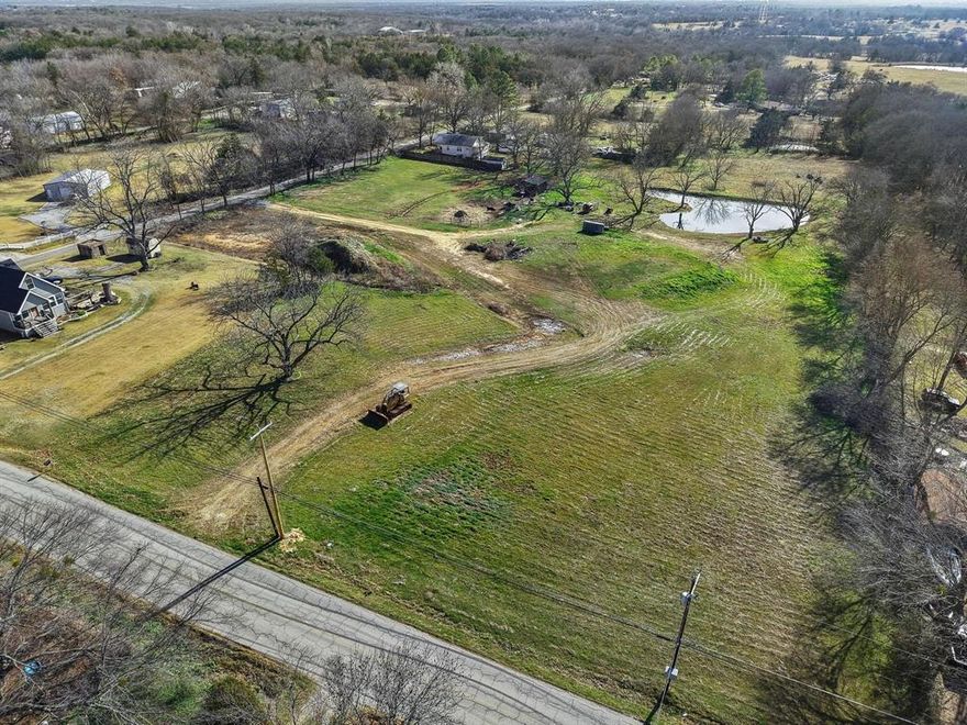Beautiful 4.4-acre tract located outside city limits, offering a great balance of open space and existing improvements. This property is well on its way to being build-ready, featuring a professionally prepared house pad with approximately $40,000 in dirt work already completed, including the pad site, pond, and multiple access points. A culvert has been properly installed for drainage. 

The land is mostly cleared with scattered trees, providing both usability and privacy. A stocked pond with Blue Gil and Bass adds to the charm of the property, while approximately one acre is fenced and ready for cattle. Improvements also include a cattle barn with lean-to, making this an excellent option for small-scale livestock or hobby farming.

No septic or electric is currently on site; however, the property is serviced by a water co-op and features multiple water lines. Drawings for a large custom home are available. 

A great opportunity for someone looking for usable acreage with major groundwork already completed, saving significant time and expense before building.