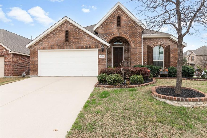 This stunning open-concept home sits proudly on a desirable corner lot and offers a seamless flow between the living, dining, and kitchen areas. Rich hardwood floors and a cozy fireplace create an inviting atmosphere in the living room, perfect for relaxing or entertaining.
The kitchen impresses with abundant cabinetry, sleek granite countertops, and generous prep space—ideal for both home cooks and entertainers alike. Elegant archways gracefully connect each living space, adding architectural charm and sophistication throughout.
The spacious primary bedroom is filled with natural light, offering a peaceful retreat at the end of the day. Its en-suite bathroom features a beautifully tiled shower, ample vanity space, and a serene, spa-like feel.
Outside, the home’s charming brick exterior is complemented by lush landscaping and a welcoming covered front porch. The covered back patio overlooks a large, fully fenced backyard—your own private outdoor oasis, perfect for gatherings, play, or quiet evenings under the Texas sky.