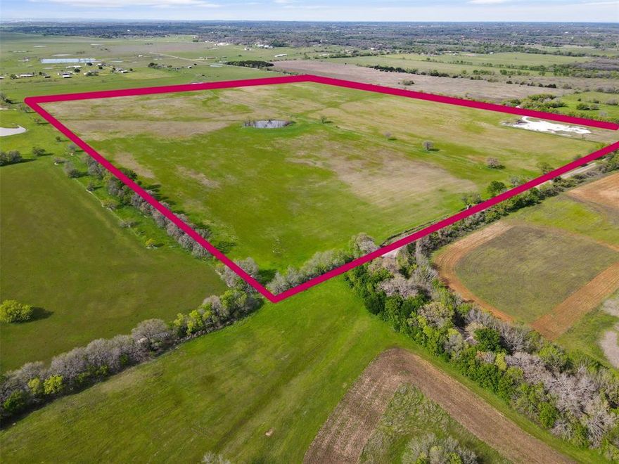 Beautiful rolling pasture land that has been used for hay production and cattle grazing.  This is a rare opportunity to purchase a tract of land offering approximately 4000 feet of road frontage with a stock pond and scattered trees alond the west border with fencing and cross fencing.  This would make a wonderful home site or a rural development. United Cooperative Services provides electricity to the proprerty and Parker Water Supply would need to be contacted regarding cost and availability of water meters. Deed restrictions include no mobile homes, no manufactured homes, no swine, no commercial ventures, and no junk yards.