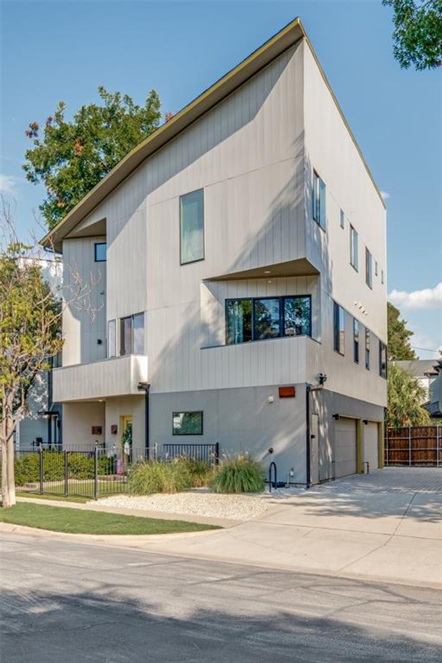 Welcome to Your Stylish City Retreat! This stunning modern three-story condo designed by Marek Architecture is the perfect blend of sleek style, comfort, and urban excitement! Nestled in flourishing East Dallas, you’ll love being just minutes from Downtown, Uptown, West Village, Deep Ellum, Henderson Avenue, and Greenville—all the best dining, shopping, and entertainment right at your fingertips! Step inside and be wowed by the light-filled open floor plan featuring towering windows, soaring ceilings, recessed lighting, and gorgeous wood floors. Entertain with ease in the spacious living area or cook like a pro in the chef-inspired kitchen, complete with: Bertazzoni range, Live-edge wooden breakfast bar & custom shelving, quartz counters, Walk-in pantry with wine cooler & pocket door! Enjoy a meal at the beautiful Live-Edge Split Ash Wooden breakfast bar and the shelving highlight the kitchen! ALL kitchen appliances and the washer and dryer STAY! Two luxurious bedrooms, each with a private ensuite, make the perfect retreats! Step out onto your two balconies and soak in the city vibes—or unwind in your front fenced-in yard with artificial turf and fresh landscaping. Other features you’ll love: Oversized two-car garage with huge storage closet! Utility on the 3rd floor for convenience. Modern fixtures & finishes throughout! No detail has been overlooked in this home that’s designed for today’s lifestyle! Whether you’re relaxing, entertaining, or exploring the city, this condo delivers the ultimate urban living experience. With prime location + sleek design + thoughtful amenities, this one is a rare gem you don’t want to miss!