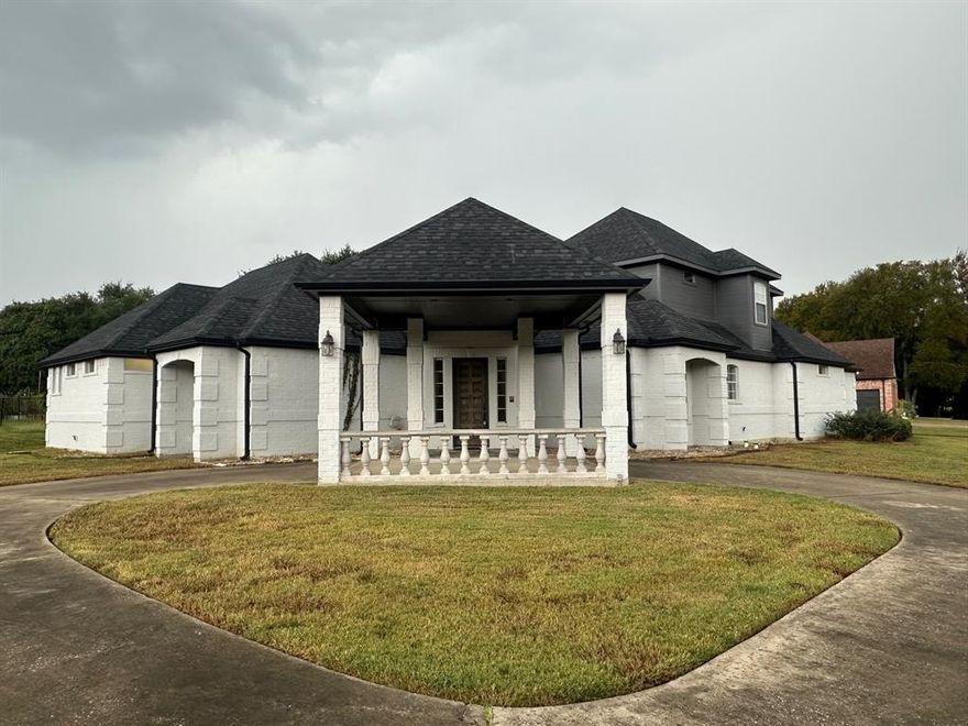 Stunning curb appeal welcomes you to this beautiful home in the highly sought-after Seis Lagos subdivision of Wylie, TX, within acclaimed Lovejoy ISD. A circular drive and white brick exterior set the tone, complemented by columns with carriage lights, elegant railing, and a covered front porch perfect for relaxing evenings.  Inside, a dramatic entryway leads to spacious living areas filled with natural light and crown moulding throughout. The formal dining room features a tray ceiling, chair rail, and a chandelier that adds timeless elegance. The inviting living room centers around a gas log fireplace, creating a warm, welcoming atmosphere.  The kitchen is both stylish and functional, showcasing an island with seating, stainless steel appliances, ample cabinetry, and a charming farm sink—a perfect setup for both everyday living and entertaining.  The primary suite is a serene retreat with a vaulted ceiling and plenty of space for a sitting area. The primary bath offers spa-like luxury with dual sinks, a stand-alone soaking tub, and a frameless glass shower, along with a spacious walk-in closet.  Additional highlights include a three-car garage with a dedicated storage area, ideal for tools, hobbies, or extra organization.  Located within the guard-gated Seis Lagos community, residents enjoy access to multiple lakes and ponds, a community pool, park, playground, and tennis courts—all designed for a vibrant, active lifestyle.  With its elegant finishes, thoughtful layout, and access to top-rated schools, this home offers the perfect combination of comfort, security, and sophistication. Don’t miss your chance to live in one of Wylie’s most desirable neighborhoods!