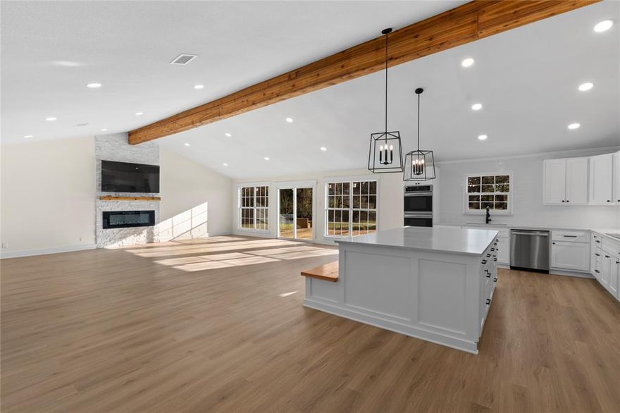 Fantastic value! Home completely remodeled and expanded to a 4 bedroom, 3 bath with approximately 2756 sq ft on huge lot with open water view! Huge open concept living room with vaulted beam ceiling and linear gas fireplace. Beautiful kitchen with quartz counter tops, shaker cabinets, 2 built in convection ovens, and huge island. Water side primary bedroom and spacious bath with soaking tub and beautiful glass surround shower. Three more spacious bedrooms and 2 more baths make this home great for full time or second home living, entertaining and sleeping a large group of family or friends. Including the land below the 325 line this lot is huge! Covered back porch and large deck. Partially fenced yard with wood playscape. One slip boathouse but with the amount of waterfront at the shoreline with a TRWD permit could possibly build larger boathouse if desired. Would make a great Short Term Rental too! Water and Sewer provided by East Cedar Creek Fresh Water Supply District. Refrigerator, washer, dryer, TVs available separately.