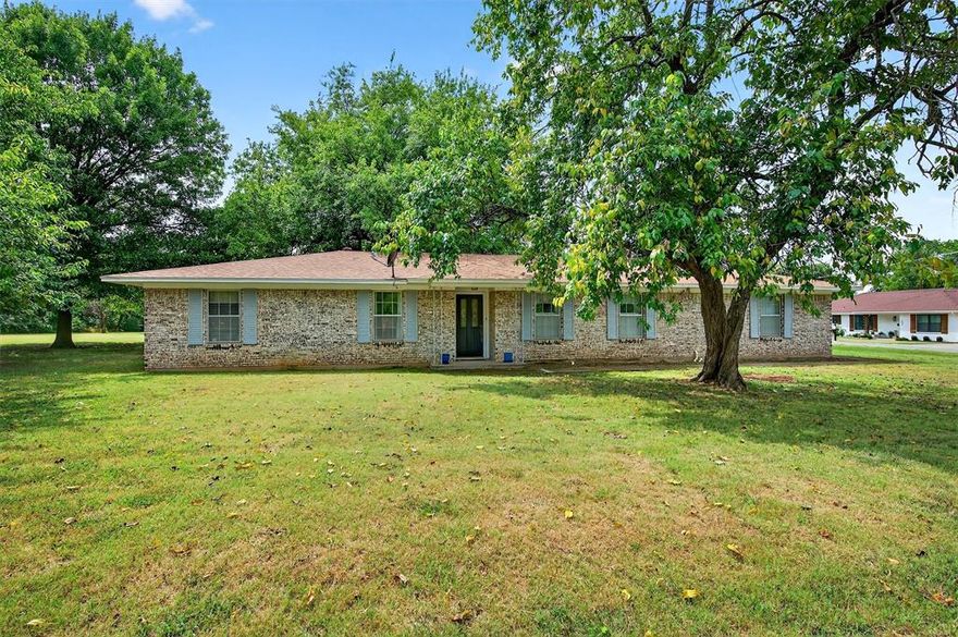 This beautifully maintained 3-bedroom, 2-bath home sits on a picturesque 1.06-acre lot filled with mature trees, offering space, serenity, and style. Inside, you’ll find wood-look tile flooring that adds warmth and durability throughout the main living areas, complemented by vaulted ceilings and a stunning double-sided fireplace—perfect for cozy evenings or entertaining guests.The kitchen is a standout, featuring stainless steel appliances, a double oven, ideal for anyone who loves to cook or host. The home’s thoughtful layout includes spacious bedrooms, updated finishes, and a comfortable, welcoming feel. Outside, enjoy the tranquility of your large, tree-lined property and the versatility of an oversized detached garage—perfect for vehicles, a workshop, or extra storage. Located in the heart of Tom Bean, this home combines small-town charm with modern amenities and plenty of room to grow.