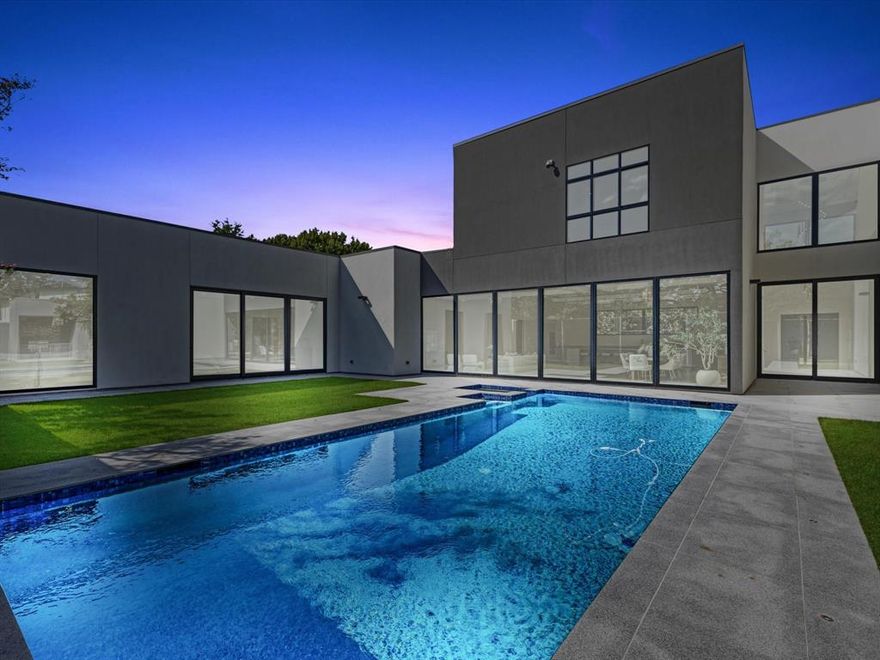 This stunning Preston Hollow home boasts 12-foot ceilings and exquisite finishes, with elegant marble and premium hardwood floors throughout. The custom pool and spa are surrounded by granite decking, a shower, restroom, and an outdoor kitchen featuring Sub-Zero and Wolf appliances. A tall aluminum and composite fence ensures privacy.
Inside, the kitchen and pantry are equipped with Thermador appliances, including two dishwashers, freezers, and ovens. European cabinetry elevates the kitchen, bathrooms, laundry, and master closets. Energy-efficient lighting and touch switches add a modern touch, while the 6'x8' ceramic pivot entry door creates a grand entrance.
Other features include frameless interior doors with European magnetic hardware, aluminum reflective windows and doors, a granite-paved driveway, and a 3-car garage with aluminum-glass doors, metallic epoxy flooring, and an EV charger.
