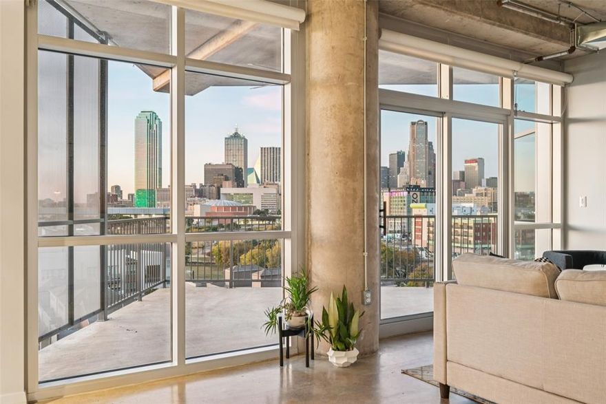 Love watching the Dallas sunset or storms roll in? This rarely available corner unit condo at The Beat Lofts offers front-row seats to Mother Nature’s show with sweeping skyline views through floor-to-ceiling windows in both bedrooms and living area. This is the only 2-bedroom, 2-bath floor plan with panoramic glass walls in every room.
Updates incl: Kitchen Aid microwave (2024) with air fryer, dehydrator, toaster oven & more; a Kitchen Aid, 5-burner glass top range with double convection oven (2025); Elfa closet system in primary (2024); HVAC replaced (2022); Murphy bed with side cabinets in guest room; both bathrooms updated (2020); Possini Euro light fixtures over kitchen island & sink (2025); speakers installed in every room and on the balcony. Smart home features with thermostat, lighting and door keypad. With 10-foot ceilings, an open floor plan and an oversized island with seating for six, this loft is ideal for entertaining. Imagine hosting your own New Year’s Eve fireworks watch party on your oversized balcony. Community amenities incl: resort-style pool w heated spa, 2 community grills, a fire pit and covered seating area on the 2nd level deck. Private dog run on the first level, and your furry friends will love the adjacent neighborhood dog park with 1-3rd of an acre to run and play. Easy access to multiple highways-freeways not to mention the added benefit of secured building entry with dbl gated parking garage with elevator access. Unit has 2 assigned parking spots.
Located 1 block from the Cedars DART station & minutes from some of Dallas’ most dynamic neighborhoods: Downtown, Farmers Market, Victory Park, Trinity Groves, Deep Ellum & more. Nearby favorite restaurants & bars incl: ZaLat Pizza, Gilley’s, Alamo Drafthouse, Four Corners Brewery, Val’s Cheesecakes, Full City Rooster, Lee Harvey’s, & more! 
Whether you’re a sunset chaser, an entertainer, or simply ready for effortless city living, this loft delivers the best of Dallas with style & soul.