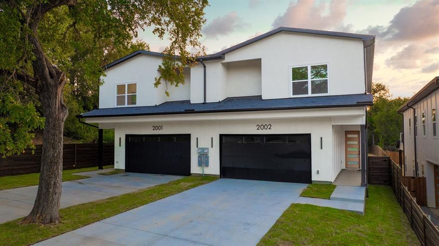 This isn’t your typical duplex. This stunning new construction is nestled in the heart of Trinity Groves, one of Dallas’ most dynamic neighborhoods. Featuring 4 bedrooms, 3.1 baths, 2,894 sq. ft. and sitting on a .310 acre lot, this home offers luxury, space, and location all in one. The first floor includes a private bedroom with full bath, perfect for guests. Upstairs, the primary suite boasts balcony access, spa style bath with soaking tub, glass shower, dual vanities, and a walk in closet with built ins. Two additional bedrooms and laundry are also on the second floor. The open concept main level highlights a chef’s kitchen with quartz countertops, custom cabinetry, designer backsplash, premium appliances, and oversized island flowing into spacious living and dining anchored by a modern fireplace. Enjoy indoor outdoor living with a covered patio, private fenced backyard, and upstairs balcony. Just steps from restaurants, nightlife, art, and shopping, come live your best life in Trinity Groves where luxury meets convenience.