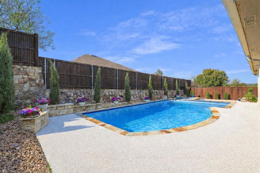 Discover this exceptional large Single Story Home featuring Private Backyard Heated Pool & Spa perfectly positioned on a hilltop lot with an unparalleled outdoor experience!  This secluded oasis delivers breathtaking vistas with stunning sunsets and treetop views. Enjoy tranquil evenings on the large patio or entertain friends and family around the sparkling heated pool and spa. Open floorplan designed for both everyday comfort and effortless entertaining. Spacious living areas flow seamlessly together, including a main living room anchored by Stone Fireplace with Gas Logs and large windows overlooking the pool and a second living area ideal for sitting area, music or entertaining.  The gourmet kitchen is the true heart of the home, featuring a massive granite island, abundant knotty alder cabinetry, stainless appliances, gas cooktop, granite countertops, travertine backsplash, walk-in pantry. A dedicated study plus an additional home-office nook provide the flexibility today’s lifestyle demands. The private primary suite is a sanctuary with tranquil views of the pool, an extended granite vanity with dual sinks, separate shower, and a massive walk-in closet 11 ft. x 12 ft. Two secondary bedrooms share a well-appointed full bathroom.  Smart home features.  OVERSIZED Garage with 30 ft. depth on one side with extra storage room and Polyaspartic flooring.  Lush Landscaping designed for beauty and low maintenance with side yard grass area for pets. Utility Room with Storage Cabinets and Sink.  Nest Thermostat and Rachio Smart Irrigation system. This McKinney gem offers a unique blend of elegance and comfort, that seamlessly combines luxury with the natural beauty of its surroundings. Zoned for McKinney ISD with prime location close to 380, 75, Hub 121 entertainment districts, Restaurants, Whole Foods, HEB, Sprouts and Trader Joe's.