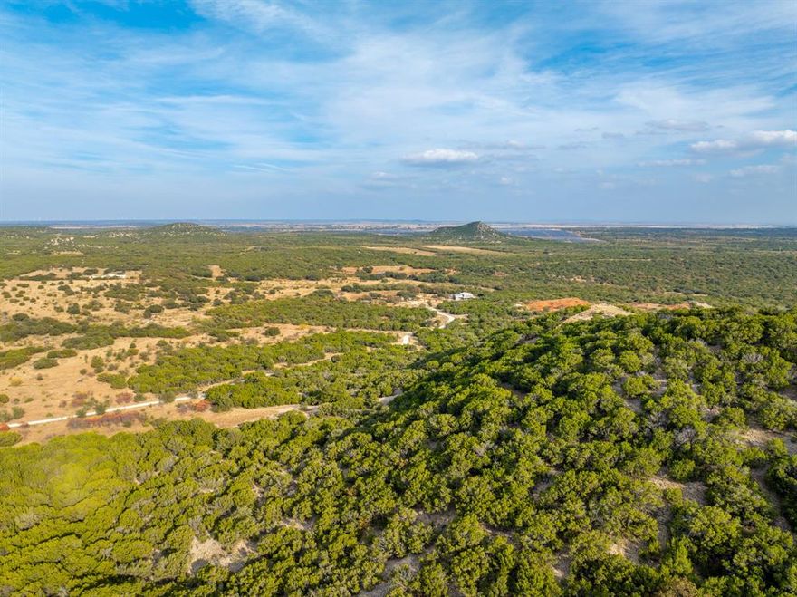 Buffalo 4 Ranch offers 1,137+ - turnkey high-fenced acres in Blackwell, Texas (Nolan & Runnels Counties). This premier game ranch features 380 ft of elevation change, rolling hills, mature oak motts, mesquite, cedar, plum thickets, diverse grasses, and approx. 150 acres of established food plots. Water is exceptional with 7 ponds, 2 electric water wells (both homes on filtration systems), and 3 solar wells feeding troughs throughout the ranch. Wildlife is abundant and includes Whitetail (Boone & Crockett to 300 ft+), Axis, Fallow, Blackbuck, Transcaspian sheep, turkey, quail, dove, ducks, and hogs. Ranch infrastructure includes 13 corn feeders, 12 protein feeders, and 11 hunting stands.
The 2,214 sq ft main home (built 2022) offers luxury lodge-style living with 18 ft ceilings, quartz countertops, custom finishes, mud-utility rooms, and a 37×40 insulated garage with commercial fridge freezer, ice machine, and temp-controlled half bath. A 40×10 covered processing area includes a walk-in freezer and electric winch. Large covered porches overlook the ranch.
The 1,683 sq ft second home (built 2017) includes granite counters, knotty alder cabinets, stained concrete floors, new HVAC, and a full-length back porch. Additional improvements include a tractor-equipment barn, two 300-gallon fuel tanks, a 15,000 lb split feed silo, cow pens, interior road system, and full perimeter high fencing.
Approx. drive times: 58 miles to Abilene Regional Airport, 233 miles to DFW, 238 miles to AUS, 386 miles to Waco.
Offered turnkey.