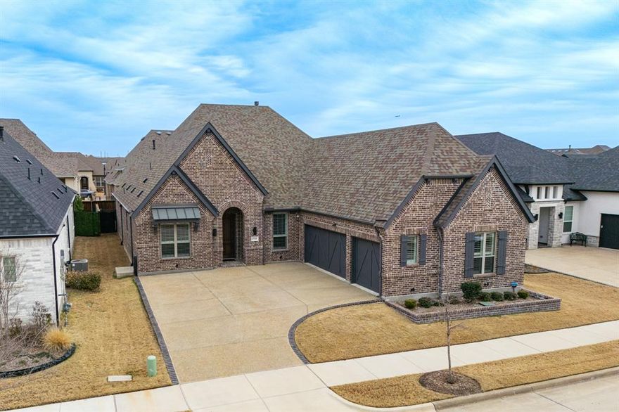 Done waiting? Done compromising? This is the one. A 2,708 sq ft single story custom Drees home in Elements at Viridian with every upgrade already done. True 3-car garage, KitchenAid appliance suite, above and below cabinet lighting, Hunter Douglas wood shutters, frameless shower, freestanding tub, quartz countertops, and wood flooring throughout. The owners put $70,000 into making this home exactly right — full upgrade list in MLS docs. Never use your patio? You will here. Always shaded with a powered bug screen, built-in fireplace, and remote fan — enjoy it year round. Turf backyard, HOA covered front yard maintenance. Still skeptical about 55+ living? Elements at Viridian is not what you're picturing. Infinity pool, pickleball, bocce ball, and a lifestyle director. Minutes from DFW Airport, AT&T Stadium, and Globe Life Field. Build new and you're looking at sticker price, Plus upgrades, and a lot of waiting. This one is move in ready. Low-maintenance. Zero compromise.