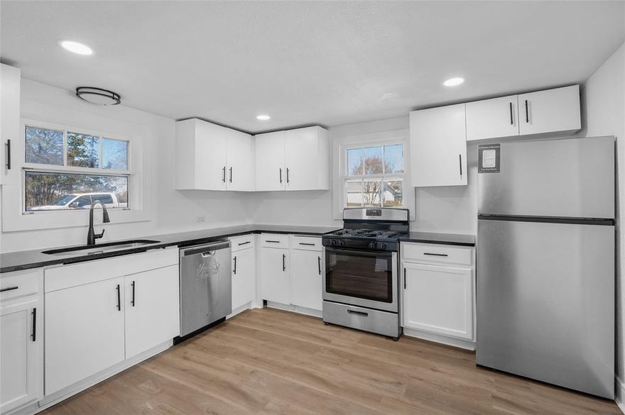 Completely refreshed and move-in ready, this charming Denison home blends modern updates with classic character on a spacious lot. Featuring a bright, open interior with fresh paint, durable luxury vinyl plank flooring, and abundant natural light throughout, this home offers comfortable living with a clean, contemporary feel.

The inviting living area is highlighted by a stylish painted brick fireplace, creating a cozy focal point while still maintaining an open flow into the rest of the home. The updated kitchen showcases crisp white cabinetry, sleek countertops, stainless steel appliances, and modern hardware perfect for everyday living or entertaining.

The bathroom has been fully renovated with a modern tub surround, updated fixtures, and tasteful finishes. Bedrooms are well-sized with neutral tones, ceiling fans, and plenty of natural light.

Outside, enjoy a large yard with mature trees, a detached storage shed for tools or equipment, and convenient rear access with parking. The exterior has been refreshed with updated siding and stone accents, offering strong curb appeal. Whether you’re looking for a primary residence, rental property, or investment opportunity, this home checks all the boxes.

Conveniently located near downtown Denison, shopping, dining, schools, and with easy access to Hwy 75. A great value for a fully updated home schedule your showing today.