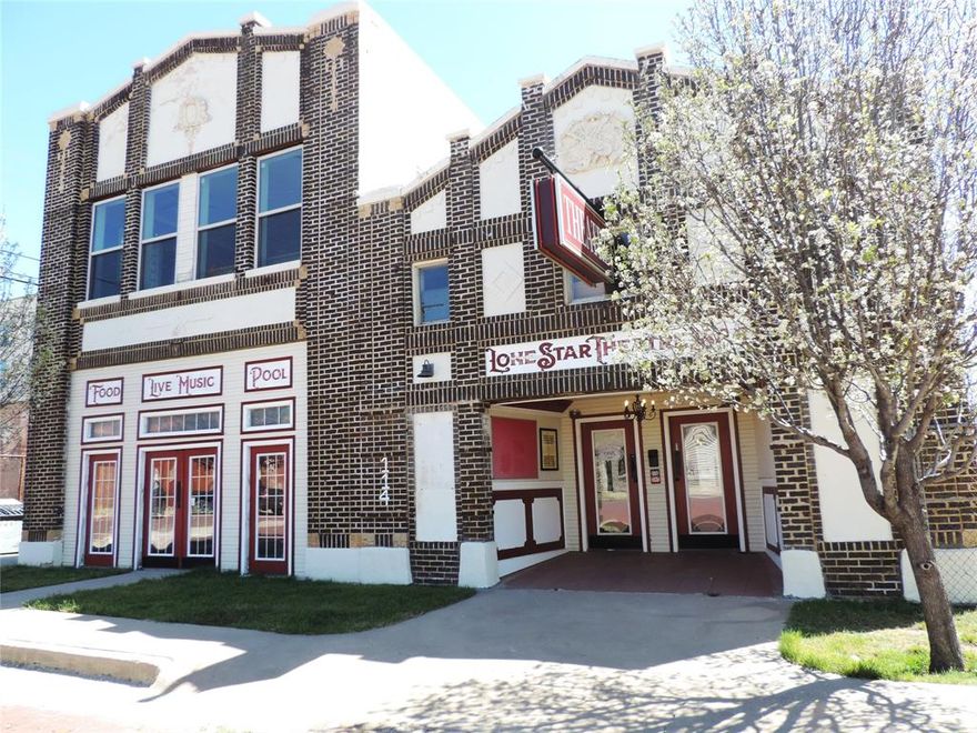 Here is your chance to own and revive a piece of legendary history! This historical building in Ranger Texas is full of possibilities. It opened as the Lone Star Theatre in 1920 and by 1941 it had been renamed Columbia Theatre. It was operated by Paramount Pictures Inc. Up the lighted stairs has 3 bedrooms, 2 full baths, living, dining and kitchen with electric fireplace and a balcony overlooking the courtyard below. The courtyard has a full service bar, stage and area seating.  A catwalk to a sitting or lounging area that overlooks the expansive theater area also below. This place could make an amazingly unique home or has unlimited business opportunity. On one side of the main floor is a wraparound bar and pool tables, on the adjacent side, the grand theater room with stage and stage lighting.  The theater room has plenty of room for theater or table seating and equipped with a commercial kitchen. The corner lot provides plenty of off-street parking or room for expansion. The sky is the limit with this property. Come check it out!