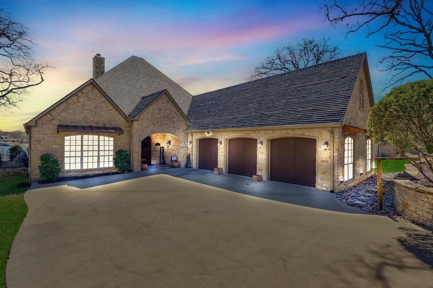 This stunning home exudes timeless elegance and modern comforts. Nestled on the sunrise side of coveted Hogan Drive, this open- concept design seamlessly integrates the kitchen with the living space, fostering an inviting atmosphere for entertaining and socializing. Indulge your culinary passions in the chef's kitchen, featuring an expansive island, pot filler, pantry and high end appliances. The stunning stone porch with retractable screen and gas fireplace is perfect for enjoying the outdoors in any season. Dive into relaxation with a luxurious swimming pool and soothing hot tub overlooking breathtaking views of the lake. Oversized boat dock offers lifts for water crafts, space to enjoy the shade and get some sun, along with easy access for swimming, or enjoying other water sports. Large game room is perfect for movie and game nights and additional sleeping space with 4 bunks built into the walls.  You do not want to miss this meticulously designed home.