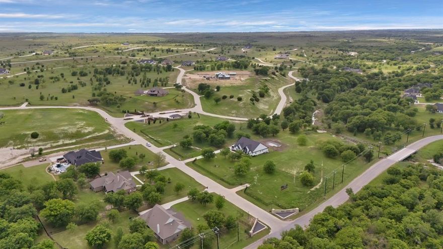 Design and build your custom dream home on this stunning 2.55-acre estate lot in Bear Creek Ranch, an exclusive gated community offering sweeping views of Fort Worth along with unforgettable sunrises and sunsets. Located in Parker County, adjacent to the historic Moncrief Ranch, this property delivers space, privacy, and luxury with no city taxes and access to the highly acclaimed Aledo ISD. You’ll have the freedom to use any custom builder with no required timeframe to build. The community upholds refined standards with a minimum 3,500 square feet of living space and a 90% exterior masonry requirement, ensuring a timeless and cohesive look throughout. Enjoy the convenience of installing your own private water wells and septic systems—eliminating monthly water bills—and utilities provided by Tri-County Electric, with propane tanks permitted. Only iron or masonry fencing is allowed, and all home plans must be approved by the HOA to maintain the integrity of the neighborhood. This elevated hilltop lot offers expansive views and the ideal setting for a private estate. Plus, the adjoining lot is also available, presenting a rare opportunity to expand your space, build a multi-generational retreat, or invest in additional land for the future. Bear Creek Ranch blends natural beauty with upscale living just minutes from Fort Worth. Whether you're ready to build now or planning for later, this is your chance to own a premier piece of Texas.