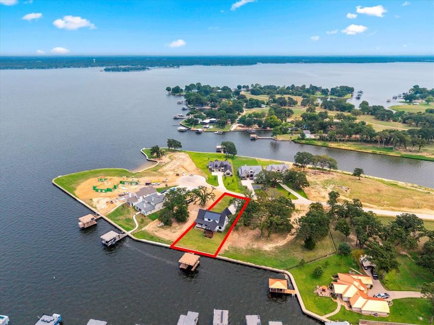 New construction by Wink Construction located in the gated waterfront community of The Groves. Situated on a .41-acre lot with approximately 93 feet of shoreline, this exceptional property rests on deep, protected water with ideal east access-perfect for boating and water activities. The open-concept design offers spacious living with a gas fireplace and a chef's kitchen featuring a gas range, ice machine, and two dishwashers, ideal for entertaining. A wonderful butler's pantry adds both style and functionality. The home includes six bedrooms, with custom details and designer finishes throughout. Enjoy peaceful cove views from the expansive covered porch, creating a perfect setting for outdoor living. The boathouse accommodates a boat, personal watercraft, and a comfortable seating area, while the large sun deck provides sweeping views of Cedar Creek Lake- an ideal blend of luxury, comfort, and lakeside lifestyle.