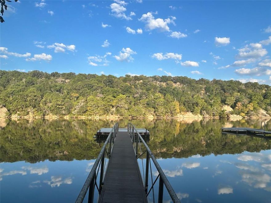 Welcome to Dragonfly Cottage at 9051 Lacy Rd in Graford — a rare chance to own deeded waterfront property on Rock Creek at Possum Kingdom Lake.

This inviting 3-bedroom, 1-bath lake home offers approximately 1,268 sq. ft. of comfortable living space on a scenic 0.46-acre lot. A welcoming living area, functional kitchen with breakfast nook, and easy-flow layout create a relaxed setting for weekends or full-time lake living. Step outside to the covered patio, where you can enjoy quiet water views and the peaceful surroundings.

A private dock, just two years old, sits a short walk from the home and provides convenient access to the calm, protected waters of Rock Creek—ideal for swimming, kayaking, and fishing. Anglers will appreciate the excellent crappie, bass, and catfish action, with gradual water depth reaching about eight feet.

The home features updated mini-split units installed and inspected by a Master Electrician, an all-electric setup, a metal roof in solid condition, and a storage building for lake essentials. Shade trees, visiting wildlife, and views of the cliffs across the water add to the serene atmosphere. Canadian geese make their yearly appearance, bringing a touch of natural charm to the setting.

This property also offers excellent short-term rental potential, making it a strong option for VRBO or Airbnb use while planning future improvements or a new-build lake home. With many new homes going up in this desirable part of Possum Kingdom Lake, opportunities like this are increasingly hard to find.

Dragonfly Cottage delivers a relaxed lake lifestyle with true water access and a peaceful environment that’s ready to enjoy.

Don’t miss your chance to secure deeded waterfront on Possum Kingdom Lake at a compelling price.