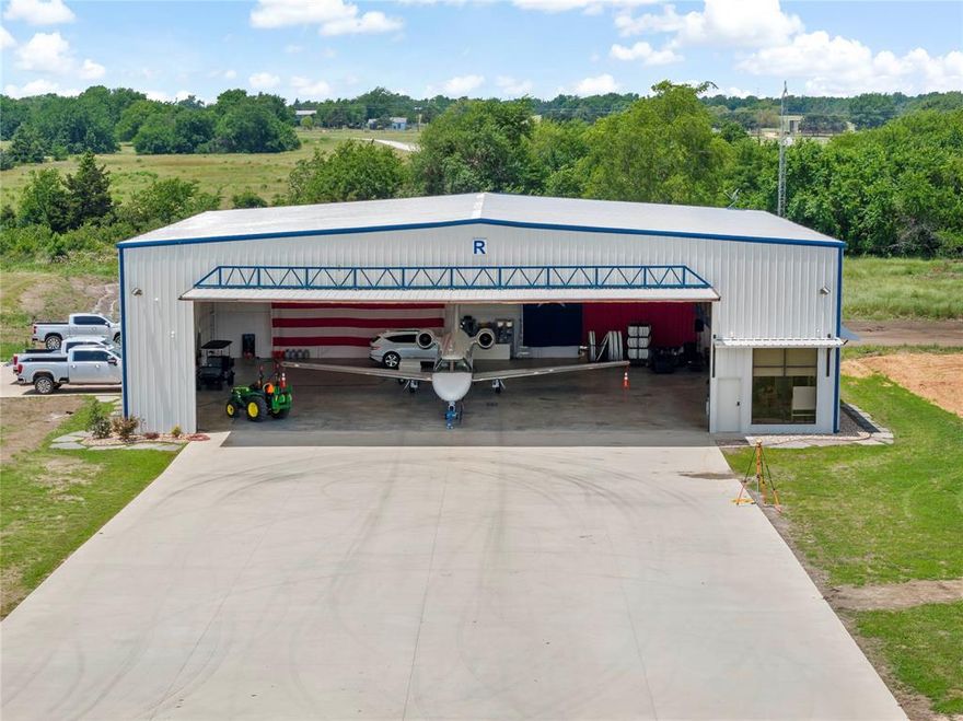 Opportunities as exceptional as this are rare. Presenting a custom-built hangar at Cox Field in the picturesque city of Paris, Texas, which serves as a hub for Northeast Texas and Southeast Oklahoma. This hangar occupies approximately 0.60 acres and features a spacious 6,400 square feet (80 x 80), conveniently situated adjacent to the taxiway. Simply open the door and taxi directly to the runway.
Cox Field boasts a primary runway measuring 6,002 feet by 100 feet, capable of accommodating aircraft weighing up to 30,000 pounds. Additionally, a comprehensive parallel taxiway system is available, comprising two segments of 4,625 feet by 150 feet, each supporting a weight of up to 26,000 pounds.
The airport waiting area offers essential amenities including restrooms, a conference room, a pilot lounge with overnight accommodations, weather and flight planning resources, and complimentary Wi-Fi. The well-lit and secure fueling and ramp areas are monitored by video surveillance for added safety. Conveniently located just minutes away from hotels, restaurants, shopping, and recreational activities, this hangar is the perfect solution for anyone who has ever dreamed of owning a plane but lacked a suitable place to store it. The photos represent a completed version of the proposed improvements.   Buyers can choose their own colors and build outs.