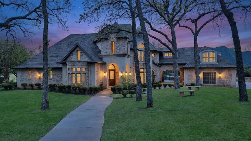 Architecturally grand and undeniably picturesque, this exceptional estate makes a statement at every turn. Nestled within the prestigious, 24-hour guarded gates of the Tour 18 community in Flower Mound, this home offers the perfect blend of luxury, privacy, and scenic beauty. Tucked away on a quiet cul-de-sac and ideally positioned between the 14th and 15th fairways of the renowned Tour 18 Golf Course, the setting is as remarkable as the home itself. Offering over 7,000 square feet of thoughtfully designed living space, this residence features 5 spacious bedrooms, 4 full bathrooms, and 2 half baths. From the moment you enter, you’re greeted by natural light, cathedral ceilings, and architectural details including custom built-ins, intricate trim work, and crown molding. The open-concept layout connects multiple living areas, each enhanced by its own fireplace, creating comfort and sophistication throughout. Recent updates include refreshed paint, updated flooring, upgraded bathrooms, and new countertops and backsplash in the kitchen—blending timeless design with modern finishes. The primary suite is a true retreat, offering generous space, a cozy fireplace, a private lounge area, and a luxurious ensuite designed for relaxation. A dedicated media room adds the perfect touch for entertainment. Step outside to your own private backyard oasis, surrounded by mature trees for seclusion. Enjoy a resort-style experience with a saltwater pool, hot tub, water features, and a fully equipped outdoor grill area. A private deck provides breathtaking golf course views. Additional highlights include a 4-car garage and a drive-through carport. Located within Argyle ISD and just minutes from Liberty Christian School, DFW Airport, Texas Motor Speedway, plus premier dining and shopping, this home offers luxury and convenience in one extraordinary package. *Square footage corrected to reflect heated living area only; garage previously included.*