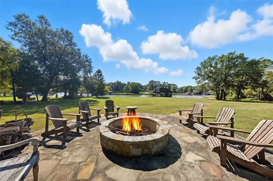 Waterfront 4 + Acre tract with so many possibilities! This tract runs along the shoreline of a deep water cove on the South end of the lake. Currently used as a family weekend retreat complete with an 1848 sq ft ultra rustic lodge style home, barn metal ceilings, reclaimed wooden floors, antler chandelier, island kitchen includes farm house apron style sink, bar seating, stone countertops, gas cooktop, built in Kitchen Aid wall of appliances stainless steel oven, microwave and refrigeration with wine chiller. The focal point is a massive stone fireplace accenting the open design great room living and game room. Built in bunk room sleeps 6 with attached full bath. Primary bedroom hosts a king size bed and full second bath. Step outdoors and you will love these breezy wrap around covered porches perfect for grilling and entertaining. Take your pick as to how to unwind! How about a little golf? There are 4 tee boxes, one large green, a zip line, hot tub, large stone firepit, a 30x40 barn or garage with roll up doors and a large sport court perfect tennis, basketball for pickle ball with some neighbors!
You will love the boat dock which is accommodating for 2 large boats and floating jet ski slips for four watercraft! Don't miss the entertainment potential of the clubhouse up above on the party deck! This is a heated and cooled space utilized as overflow bunk space and game room! This property is ideal for a corporate retreat, hosting private events, you could add multiple cabins, short term rental is allowed. Excellent opportunity to purchase a property that offers all of the reminders of a summer camp location including ample  room  to park and play!