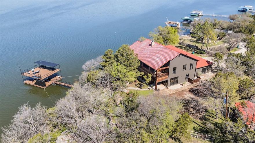 Welcome to Big Cedar Lodge, a stunning 2 story home located on beautiful Possum Kingdom Lake. Enjoy breathtaking lake views from every room! A spacious, newly renovated open-concept living, dining and kitchen area offers panoramic lake views from the wall of windows. Enjoy outdoor bliss, while relaxing on the wraparound screened in porch, perfect for sipping morning coffee or hosting gatherings. The new living area features a rock wall fireplace, cedar beams and a massive granite bar with a luxurious leather finish. A second rock fireplace is the focal point from the massive upstairs deck with expansive lake views. This six bedroom retreat with a cozy bunkhouse and 3.5 baths will provide plenty of room for everyone. Enjoy the scenic surroundings on an acre of beautifully landscaped grounds with the natural beauty of the lake on your private two story dock in a beautiful cove. Whether you seek a serene retreat or an entertainer’s paradise, Big Cedar Lodge has it all.
