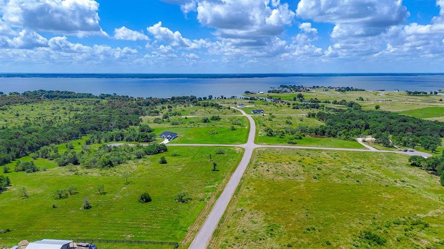 Your Lake Life Starts Here! This prime 1-acre corner lot sits inside a beautiful gated community on Richland-Chambers Reservoir — one of Texas’ best-kept secrets for boating, fishing, and laid-back weekends. Enjoy paved roads, private boat docks, a swimming beach, owners’ park and pavilion, plus tranquil lake views. There’s no deadline to build, so bring your dream home plans when you’re ready. Just an hour from Dallas and a quick drive from Houston, this peaceful community offers the perfect mix of wide-open skies, quiet nights, and easy access to big-city perks. Secure your own slice of lakeside living and start planning a lifetime of memories by the water.