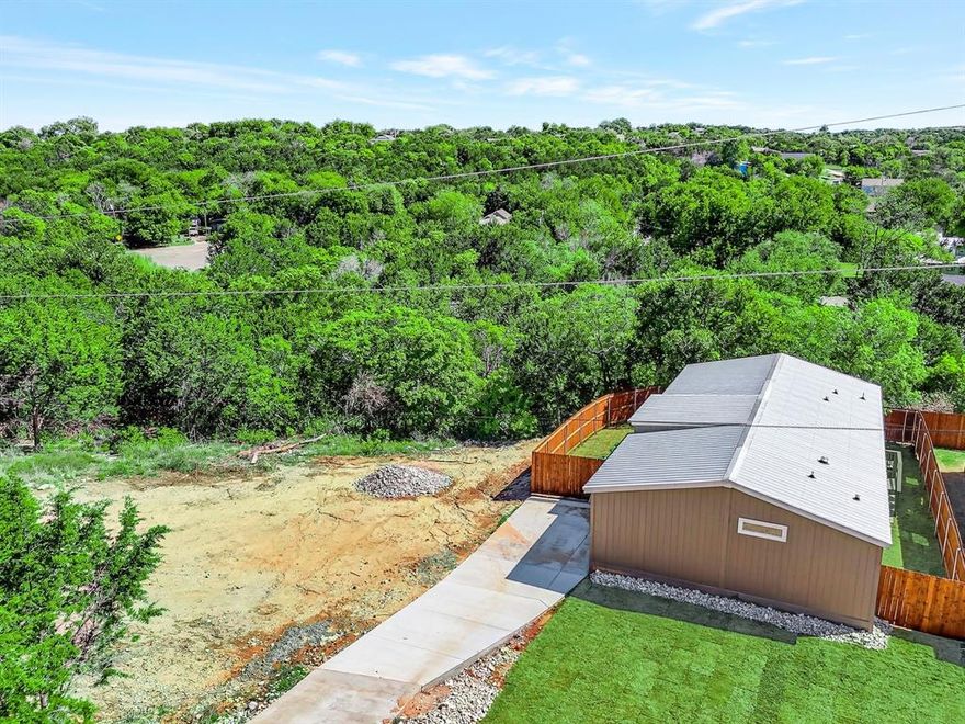 Like new doublewide manufactured home located in the community of Comanche Cove. 28 foot wide by 52 foot long featuring 1454 square feet and built in 2024. 4 full bedrooms and 3 full bathrooms. This home has so much to offer! Located far off the road down a hill for the ultimate in privacy! Spectacular view of Comanche Peak from your back door. Full concrete driveway, fully fenced back and side yard with pre stained cedar privacy fencing. Sod front and back yard, front and back decks, hardi board siding, hardi board skirting, and a full METAL ROOF! Brand new aerobic drip system septic system installed. So, let's talk about the inside of this beautiful home! Laminate wood flooring throughout with NO carpet. Double pane storm windows throughout, textured ceilings throughout, overhead air vents throughout! Kitchen includes all appliances! Refrigerator, stove, dishwasher, and built in microwave. Kitchen also features a very large and functional kitchen island and numerous white cabinets. Full size and separate utility room with full size washer and dryer connections. Breakfast area is located just off the kitchen. Very large and open living room with numerous large windows for all that natural light! Primary bedroom is super sized with a large walk in closet and ensuite bath. Primary bathroom features 2 sinks, garden tub, separate shower, and elegant ship lap siding on one wall. Bedrooms 2, 3, and 4 are the perfect size for the kids or to use as an office if needed! Bathroom 2 is very functional and features a tub shower combo. Full 2 year warranty included with sale. Comanche Cove offers a clubhouse, community pool, park, and Lake Granbury access. This doublewide manufactured home has so much to offer its new owner. A must see home priced to sell!