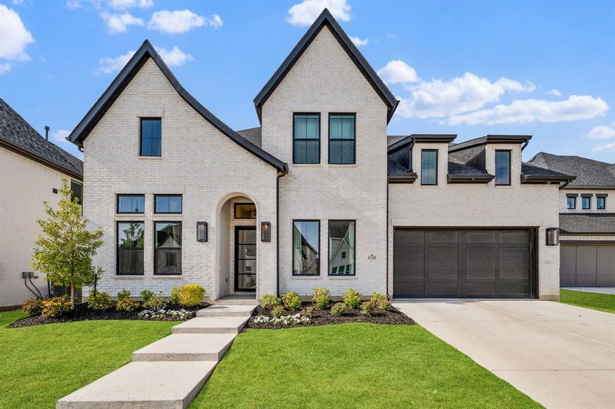 Welcome to this beautifully designed home in one of McKinney’s most sought-after communities, where elevated finishes and thoughtful design come together seamlessly. The main living area makes a lasting impression with soaring vaulted ceilings, exposed wood beams, a striking fireplace feature wall, and expansive sliding doors that create a seamless indoor-outdoor connection to the covered patio. The kitchen is both functional and refined, featuring a waterfall island, full-height cabinetry, designer lighting, and a premium appliance package, all opening effortlessly to the living and dining areas filled with natural light. A designated office with custom built-ins offers a polished work-from-home space, while a private media room provides the perfect setting for entertaining. The primary suite is privately positioned and showcases vaulted ceilings, abundant natural light, and a spa-inspired bath complete with a freestanding soaking tub, oversized walk-in shower, dual vanities, and extensive cabinetry. Upstairs, additional living space with an open-to-below design enhances the home’s airy feel and provides added flexibility. Additional highlights include a wet bar, wide-plank wood flooring, curated designer finishes throughout, and a layout designed for both everyday living and entertaining. Situated on a well-sized lot with a covered outdoor living area, this home offers a refined blend of modern style and comfort, all within close proximity to top-rated McKinney ISD schools, dining, shopping, and major commuting routes.